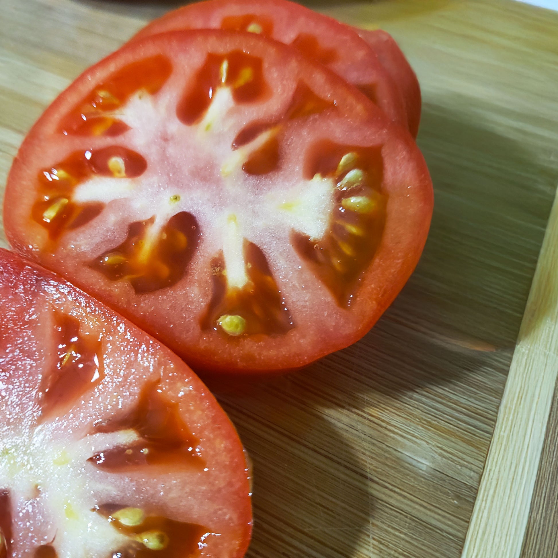 tomato sliced open with red flesh